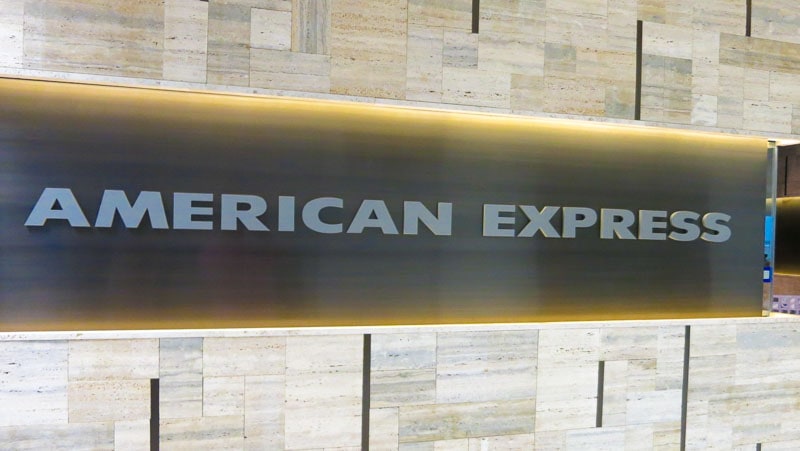 painted metallic silver acrylic letters mounted flush on panel american express lounge wall