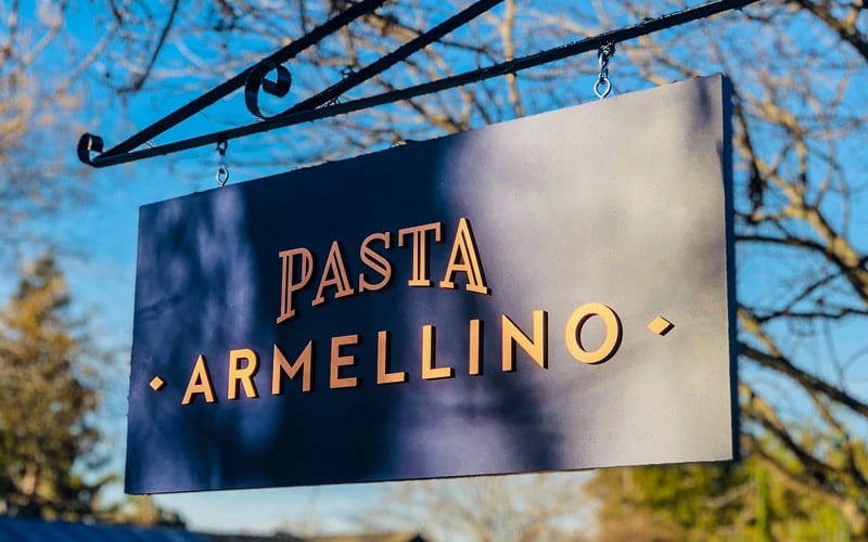 Brushed Copper Letters on hanging Painted Acrylic Panel outside restaurant