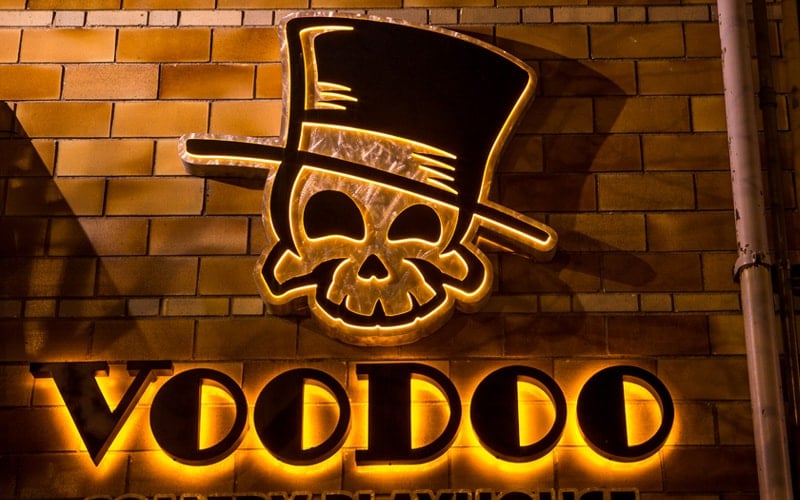 custom edge lit letters and logo for tattoo shop mounted outside on brick