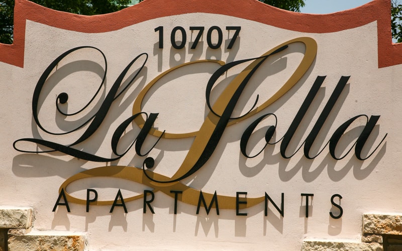 painted solid cut aluminum letters in black and gold for la jolla apartments complex entrance monument