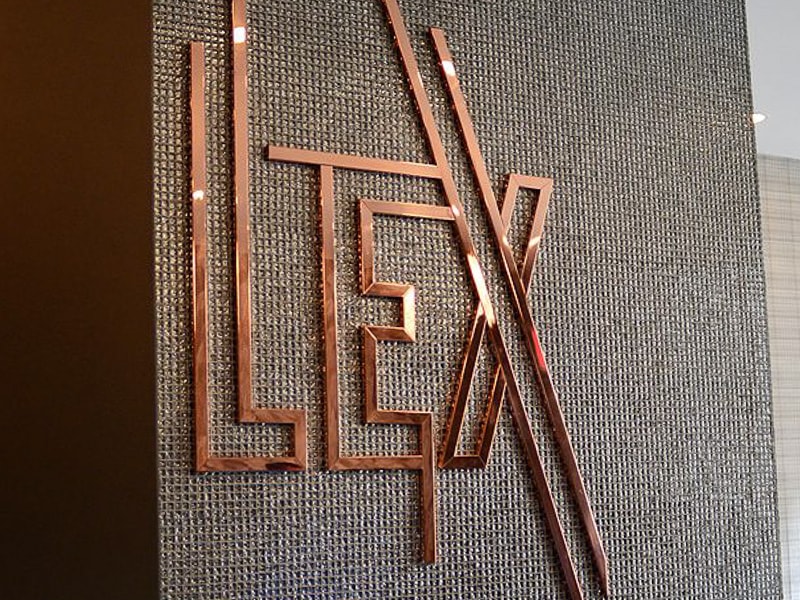 polished copper metal logo lex hotel lobby 2