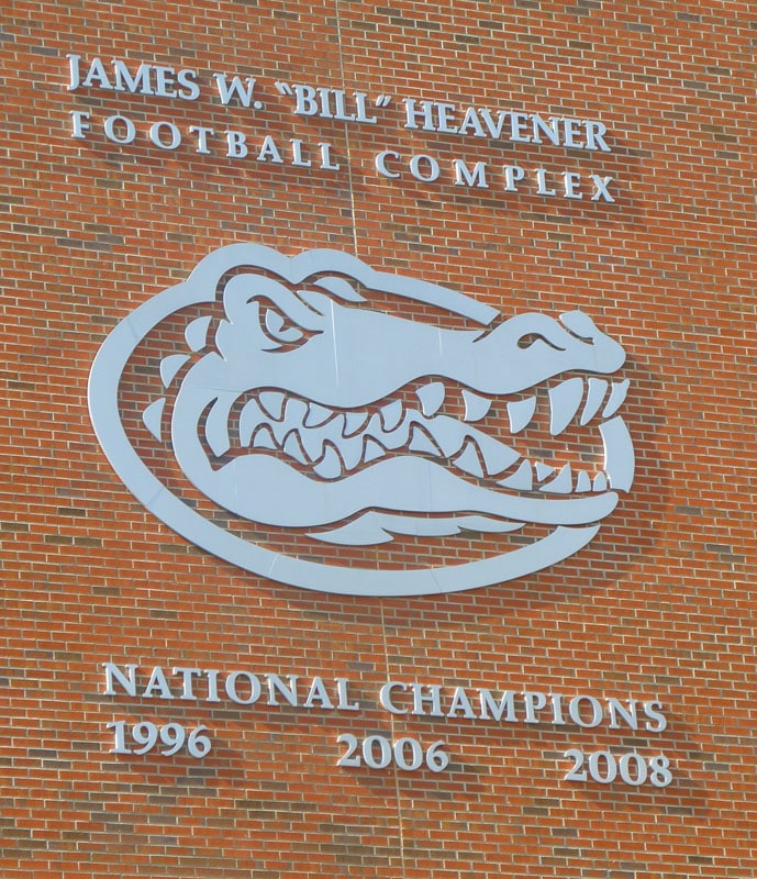 large solid cut brushed stainless steel logo and letters for university of florida outside on brick wall