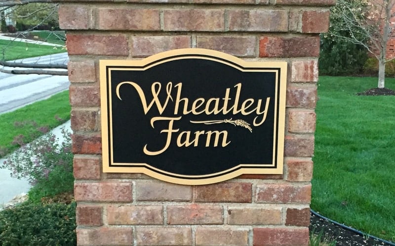 cast brushed bronze plaque with double line border with black background for neighborhood entrance