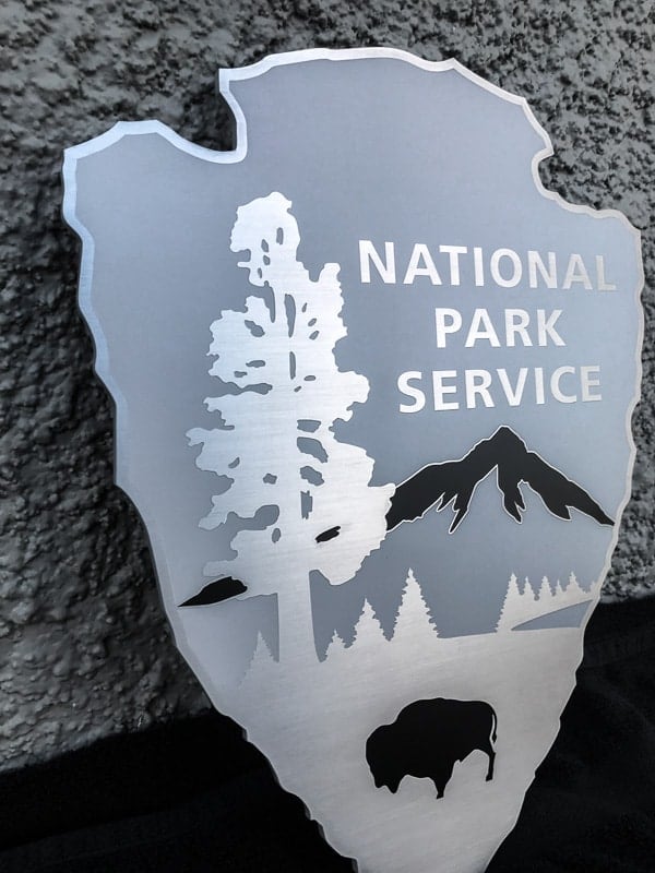 brushed etched stainless steel plaque with grey and black background custom shape for park police