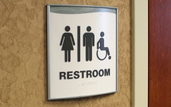 curved wall sign for restroom with ada braille