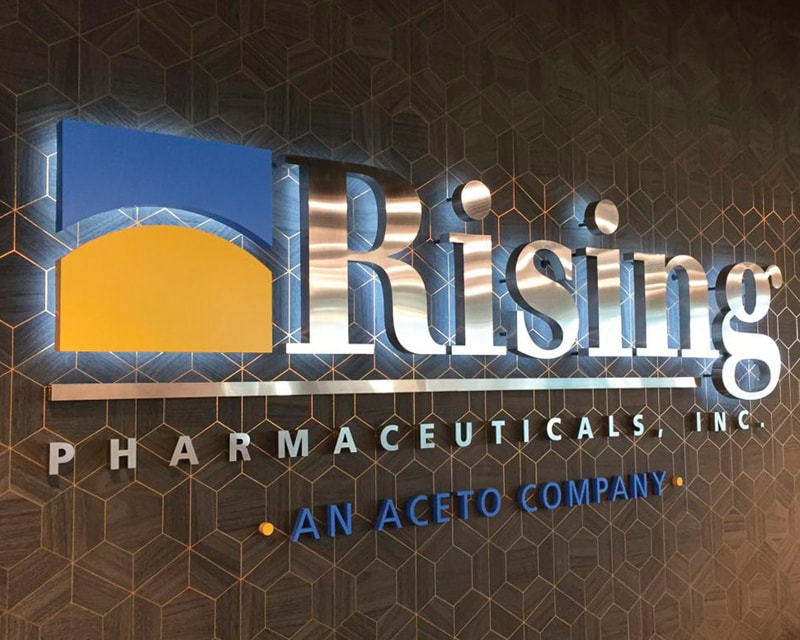 backlit letters logo sign interior lobby in polished stainless steel for rising pharm