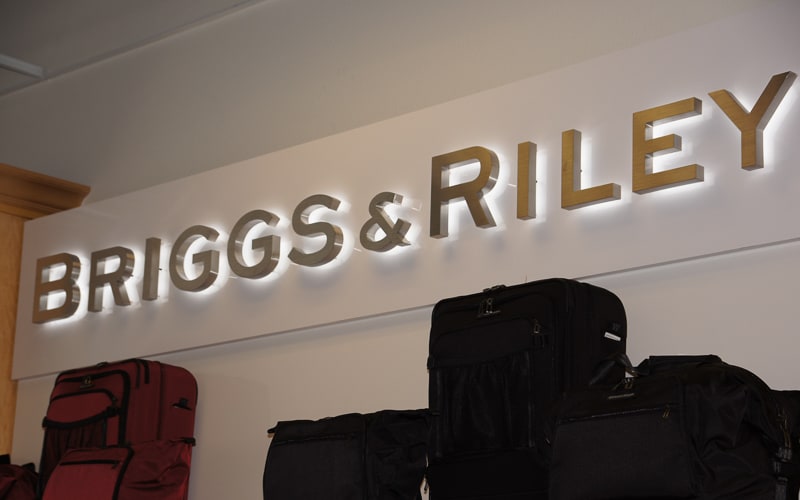 backlit halo letters in brushed stainless steel and white LEDs mounted inside briggs riley store