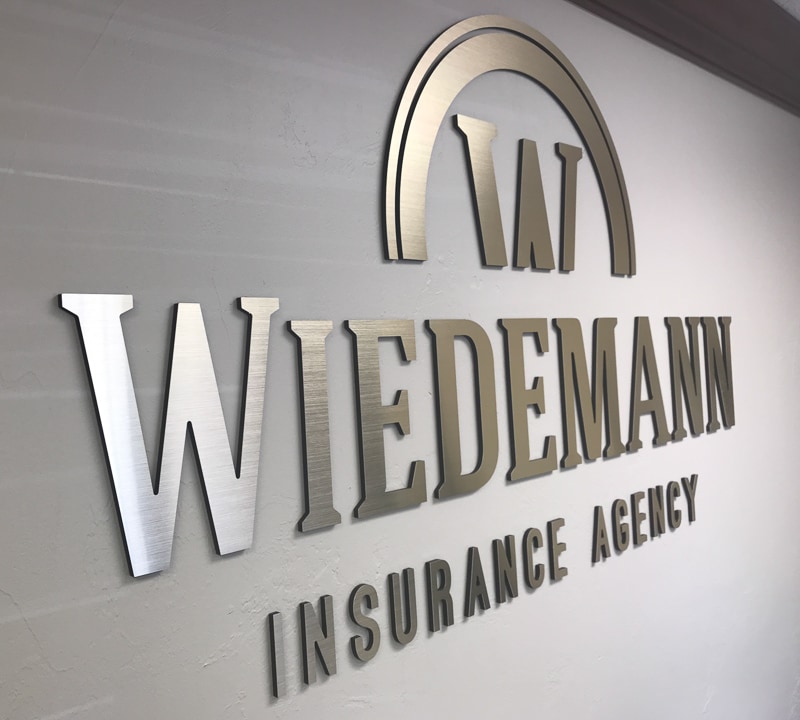 metal faced acrylic sign in brushed aluminum on black acrylic mounted for Widemann Insurance interior lobby wall