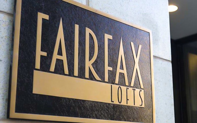 cast bronze plaque in brushed bronze finish and leatherette background for outside lofts apartments