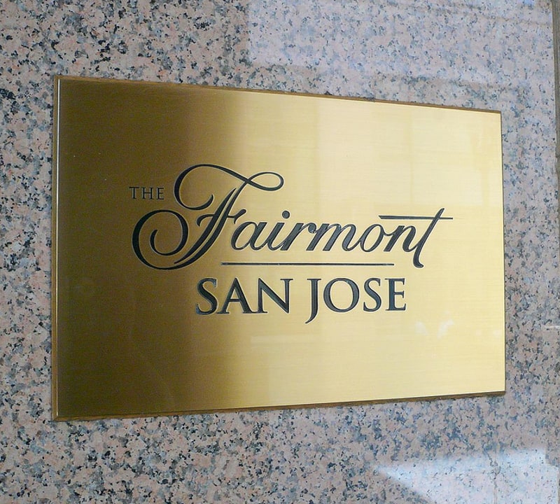 brushed etched brass plaque with black text and logo for outside hotel