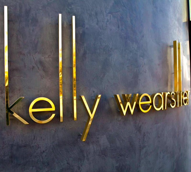 thick polished brass metal letters outside retail clothing store