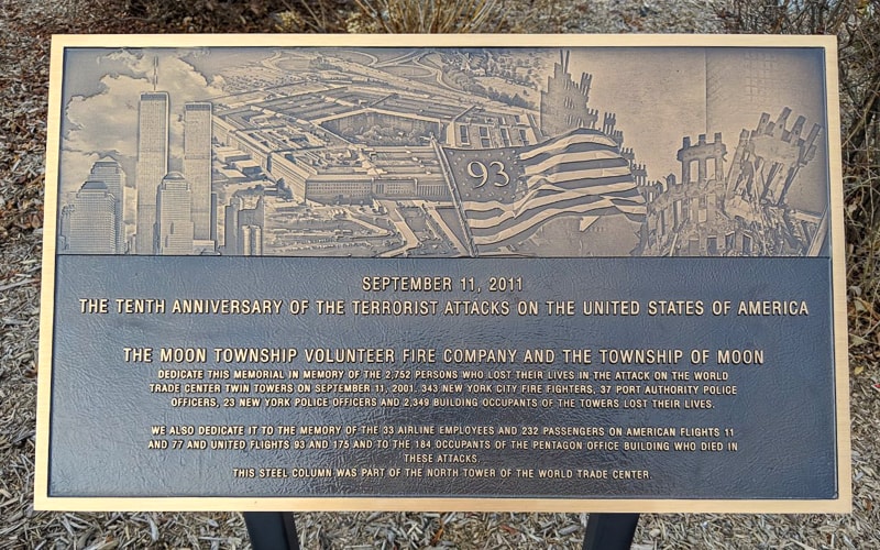 cast bronze plaque with photo portrait for september 11 memorial dedication mounted on post