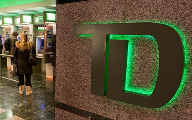 metal interior sign with green backlight on stone wall