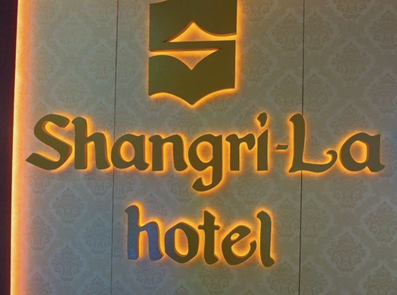 custom interior backlit sign with orange backlight on tan and white wall
